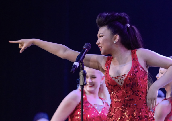 Senior Bella Tran performs on stage with her choir, the Accents. 